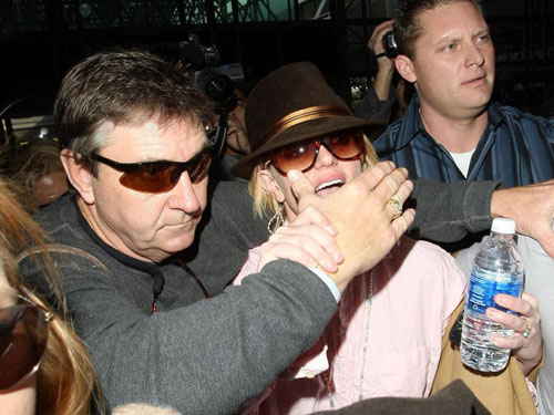 RESTRICTIONS APPLY: No smiling! Britney Spears muzzled by overprotective dad Jamie as she leaves LA for her European tour